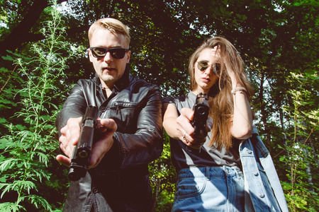 special agents armed with guns looking for criminals in the woodsの写真素材