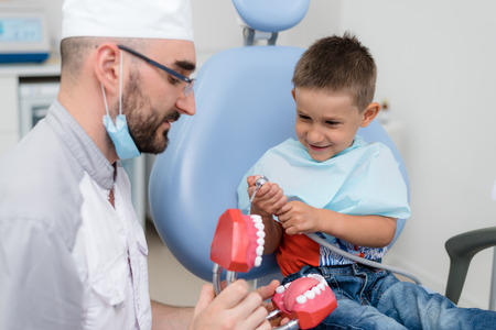 doctor orthodontist playing with the boy in the dental office.