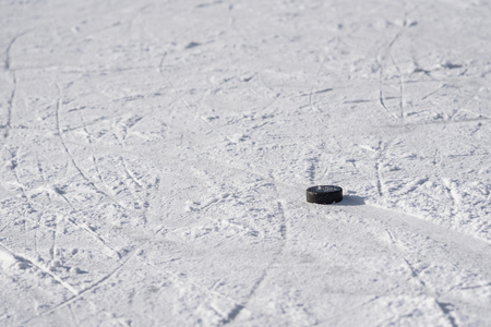 hockey puck lies on ice during the dayの写真素材