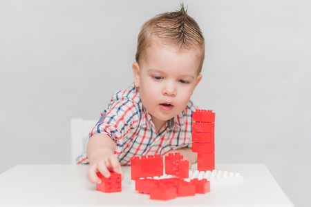 the kid plays with the designer at homeの写真素材