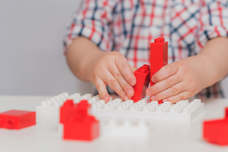 the kid plays with the designer at homeの写真素材