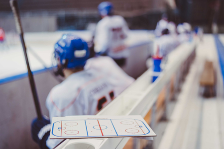 hockey players sit on the bench in the stadiumの写真素材