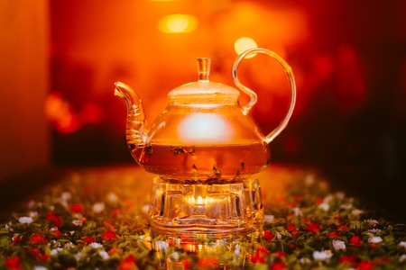 tea brewed in a transparent kettle is on the tableの写真素材