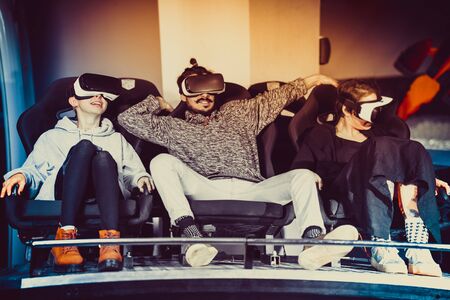 friends in virtual glasses watching movies in the cinema with special effectsの写真素材