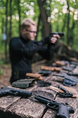 the guy in the woods is cleaning his weaponの写真素材