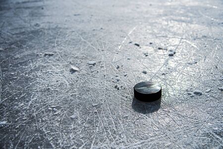 hockey puck lies on the snow macro