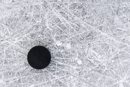 hockey puck lies on the snow macroの写真素材