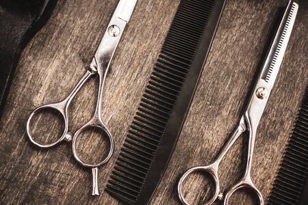 metal scissors and black combs for haircuts are in the hairdresserの写真素材