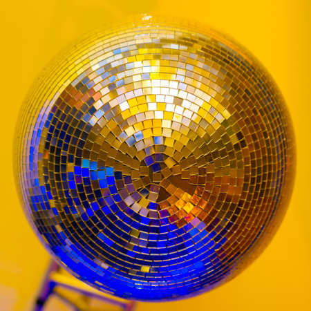 Big disco ball on a colored backgroundの写真素材