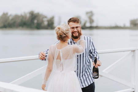 The bride and groom hugging on the wharf by the river.の写真素材