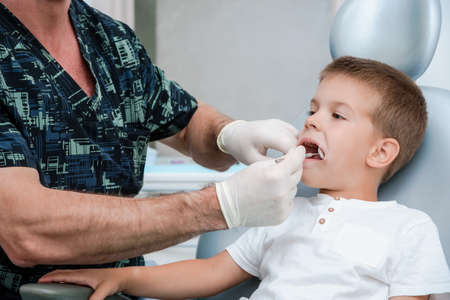 Child at the dentist's office at the clinicの写真素材