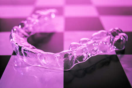 Plastic braces dentistry retainers to straighten teeth. Invisible dental braces lie on a...