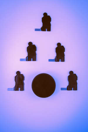 Hockey players team and puck on a blue background.