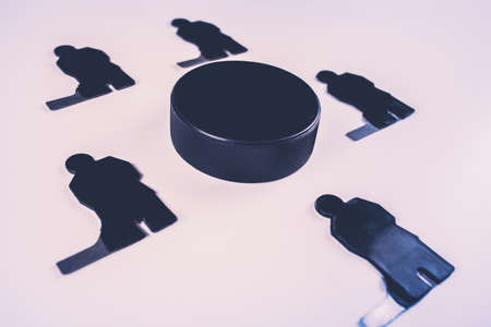 A team of five hockey players and one puck on a blue background.の写真素材