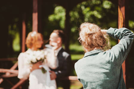Wedding photographer photographing a couple in nature