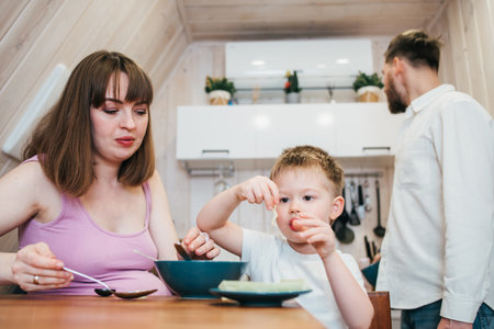 Very happy family eating pasta in the kitchenの写真素材