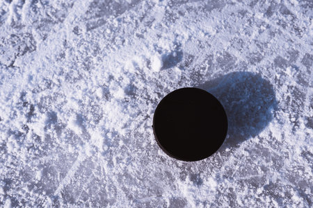 hockey puck lies on the snow macroの写真素材