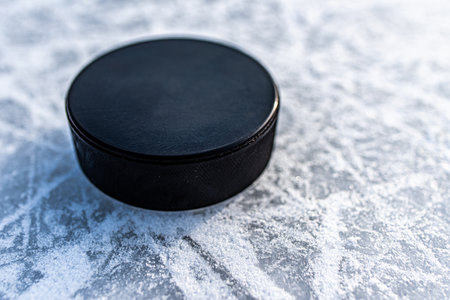 hockey puck lies on the snow macroの写真素材