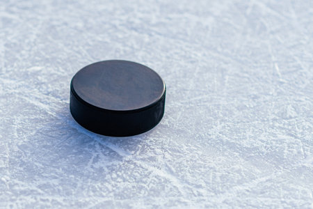 hockey puck lies on the snow macroの写真素材