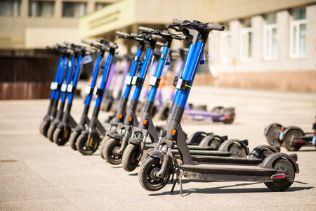 Electric scooters are parked in the city center. public mobile transport stand outsideの写真素材