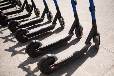 Electric scooters are parked in the city center. public mobile transport stand outsideの写真素材