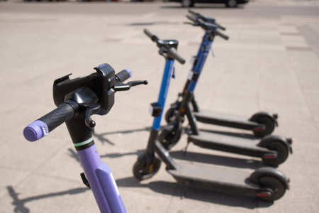 Electric scooters are parked in the city center. public mobile transport stand outsideの写真素材