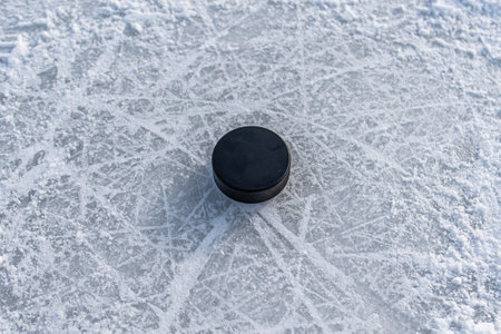 hockey puck lies on the snow macroの写真素材