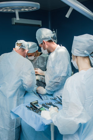 A team of surgeons performs a complex operation to remove a pancreatic cyst using medical instrumentsの写真素材