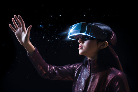 Beautiful girl in virtual reality glasses touches the air with her hand on a black backgroundの素材