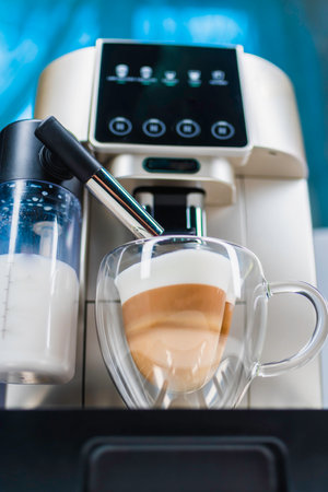 Modern coffee machine with glass bowl, makes coffee, cappuccino, espresso and latte in the kitchenの写真素材