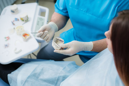 Orthodontist showed how the plate works to flatten teeth on jawsの写真素材