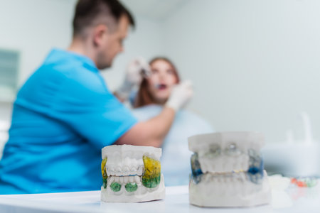 the doctor examines the oral cavity of the patientの写真素材