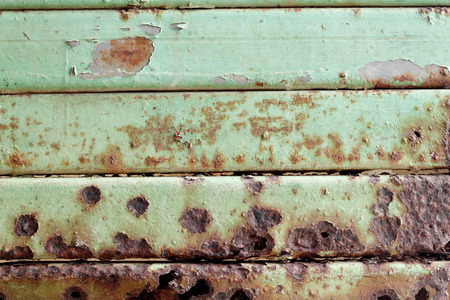 Abstract green steel door with rusty
