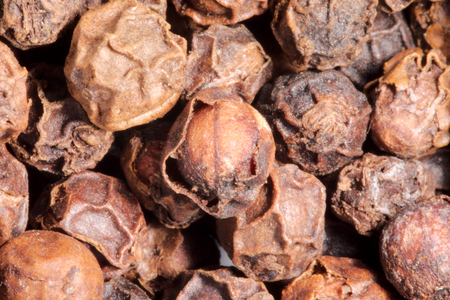 closeup view of black dried pepper cornsの写真素材