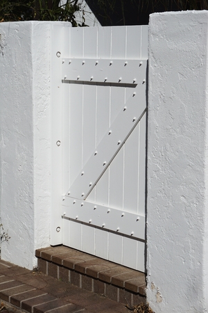 Freshly painted white entry gate vertical background