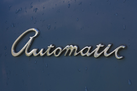 The word automatic in chrome on a blue painted backgroundの写真素材