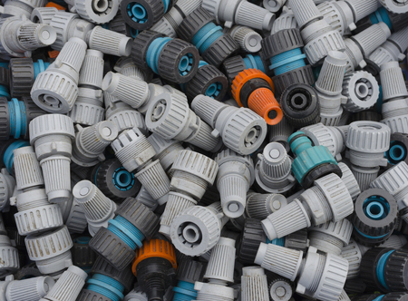 A selection of old and dusty garden hose connectors and spray nozzlesの写真素材