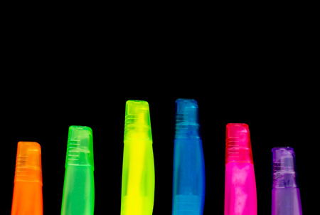 Set of 6 colourful marker pens on a black bankground with copyspace.の写真素材