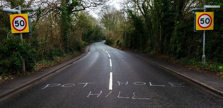 A road in Flintshire with the phrase pothole hill. Despite the road surface where the phrase is...