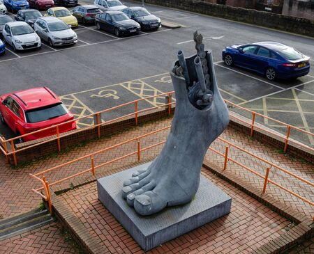 Flint, UK: Feb 11, 2020: The public sculpture by Brian Fell, named Footplate, stands beside a railway station, car park & the National Cycle Network. The 3 metre tall structure was installed in 1999のeditorial素材