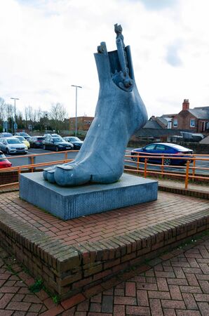 Flint, UK: Feb 11, 2020: The public sculpture by Brian Fell, named Footplate, stands beside a railway station, car park & the National Cycle Network. The 3 metre tall structure was installed in 1999のeditorial素材