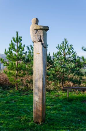 Greenfield, Flintshire, UK: Feb 6, 2020: The Lookout is a carved wood sculpture by Mike Owens. The sculpture faces the River Dee estuary on the North Wales Coastal Path.のeditorial素材