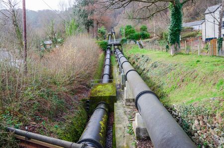 Dual pipeline on the hillside, which feeds water to the hydro electric power station in Dolgarrog, North Wales.の写真素材