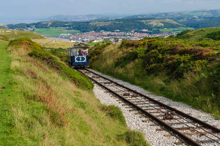 Llandudno, Wales, UK: Aug 27, 2019: Tourists enjoy riding the historic Great Orme Tramway. The only...