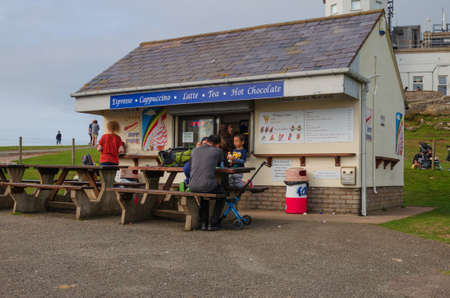 Llandudno, UK: Aug 27, 2019: Tourists enjoying the sunshine at the snack bar which is part of the Great Orme Summit Complex.のeditorial素材