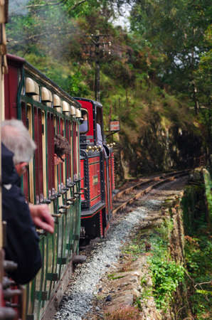 Ffestiniog, North Wales, UK: Sep 14, 2017: A narrow gauge steam train hauls tourist carriages through the countryside on the Ffestiniog Railwayのeditorial素材
