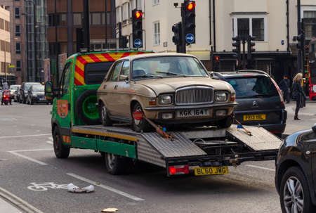 London, UK: Dec 2, 2017: A motor car transporter is seen in central London, carrying a 1979 Vanden Plas 1.5 litre saloon car. The car was better known as the Austin Allegro.のeditorial素材