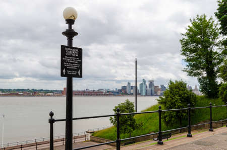 Wallasey, UK: Jun 23, 2020: A sign states that the Memorial Gardens in front of Wallasey Town Hall are dedicated to the 96 victims of Hillsborough. The Liverpool skyline is in the background.のeditorial素材