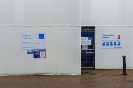 Chester; UK: Jan 29, 2021: Safety notices are displayed prominently on plain hoardings around a...