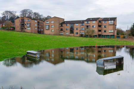 Mold, Flintshire; UK: Jan 28, 2021: Sheep feeders have been partially submerged in a field which has been badly flooded during the recent heavy rainfall.のeditorial素材